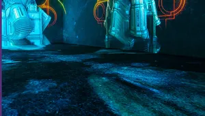 Futuristic digital art installation with illuminated architectural structures and colorful geometric shapes projected on the walls in a dark room.