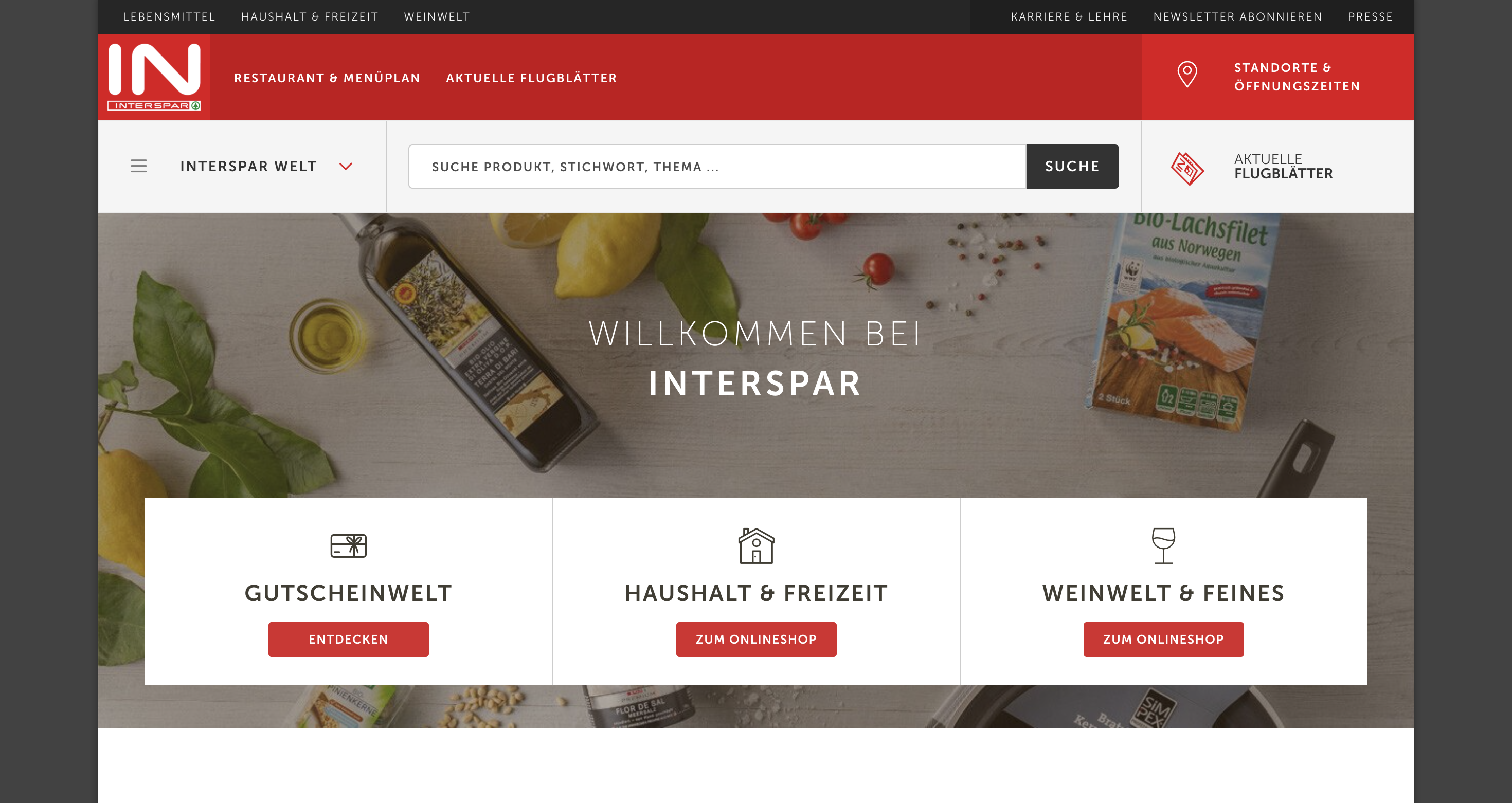 INTERSPAR website homepage featuring categories for vouchers, household, leisure, and fine wines. Includes search bar and navigation links.