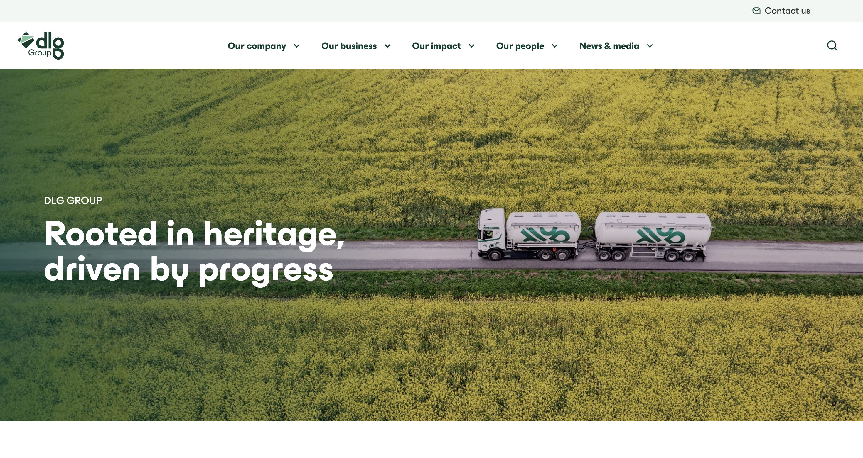 DLG Group homepage hero banner showing a tanker truck driving along a rural road between large yellow fields, with the text “Rooted in heritage, driven by progress.”