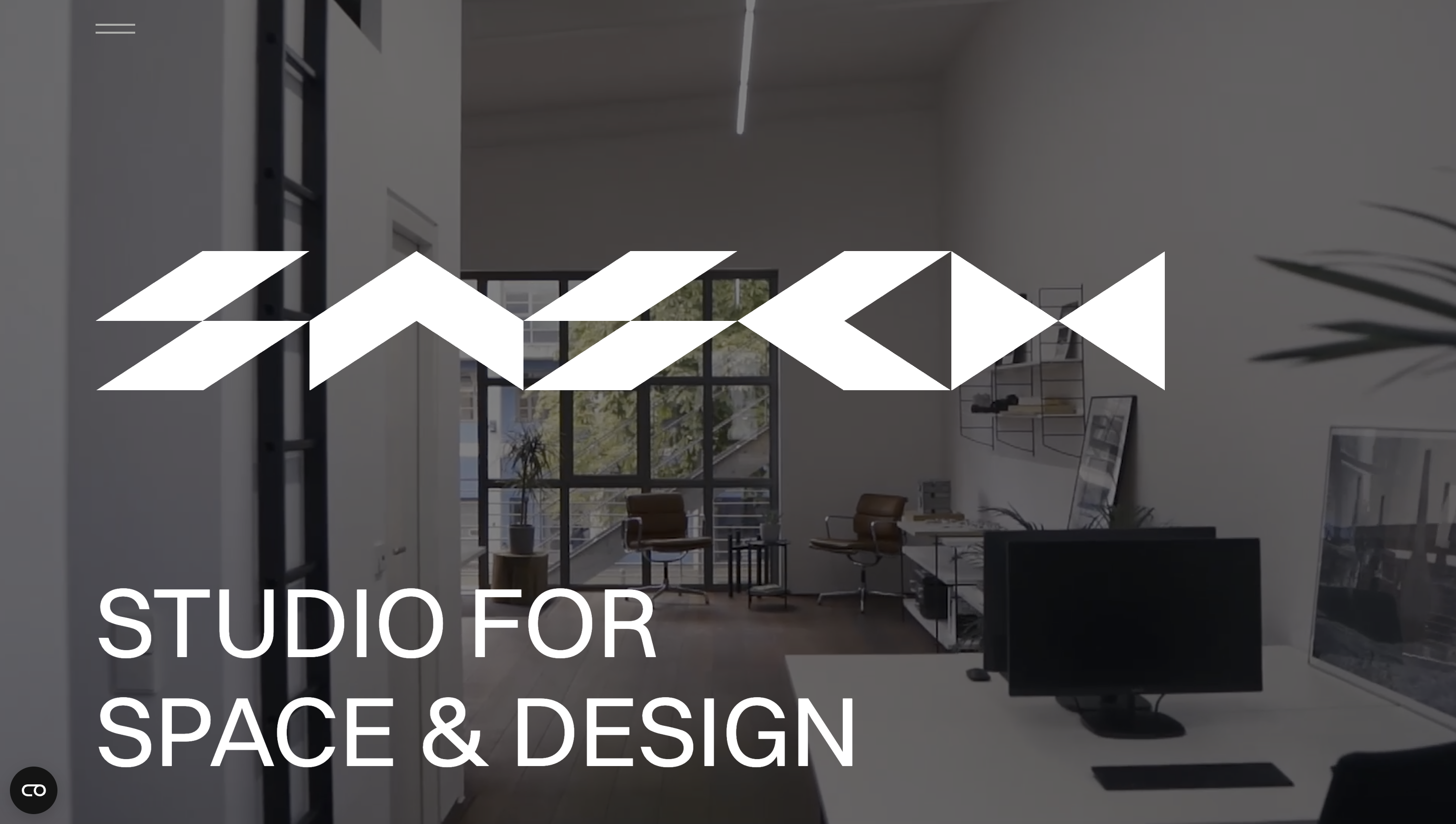 Modern workspace with minimalist design, featuring a logo and the text "Studio for Space & Design" overlaying the image.