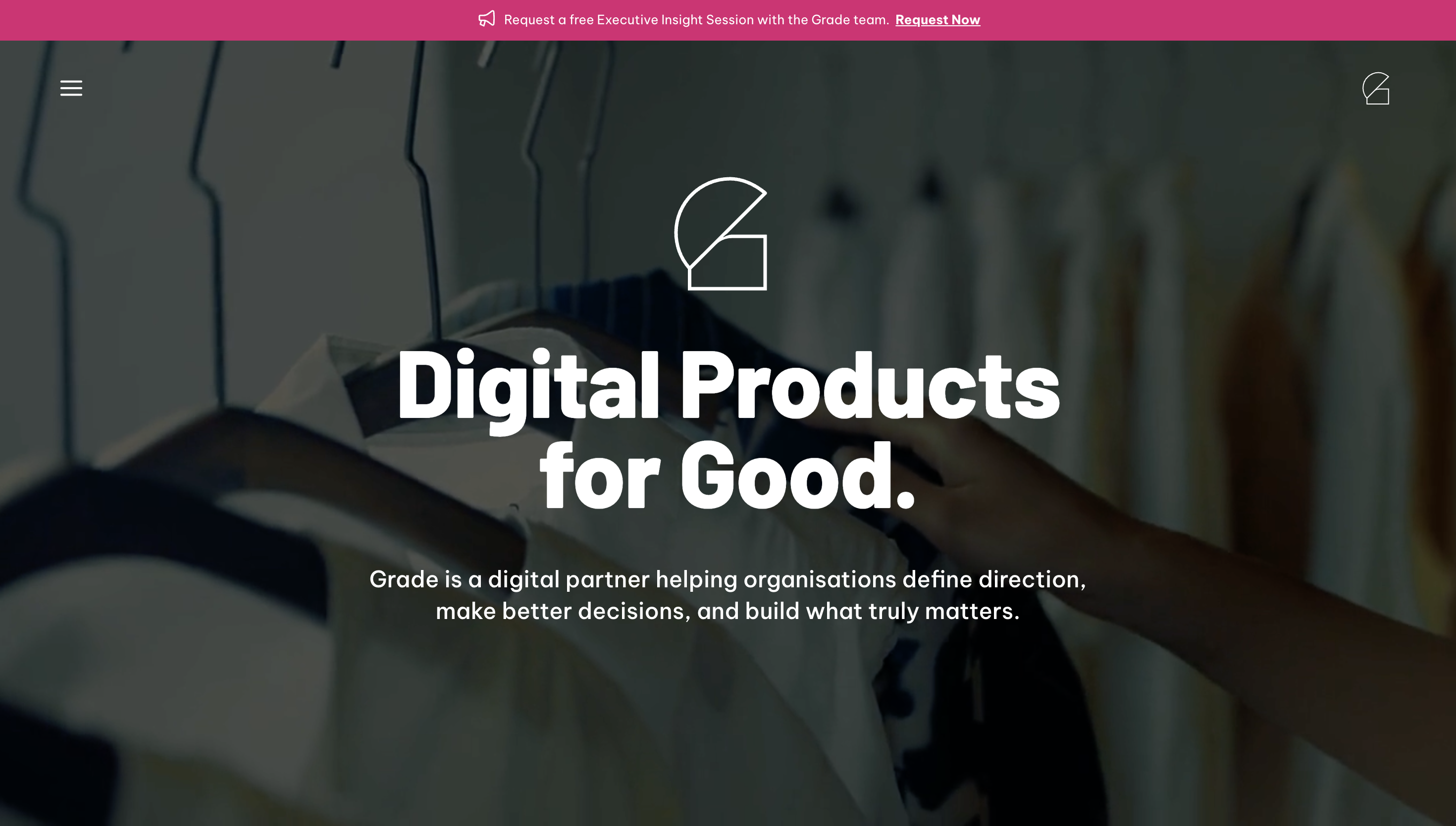 Website with blurred hangers background and text: "Digital Products for Good. Grade helps organizations define direction and make better decisions."