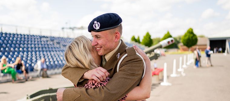 Parent hugging their son at AFC pass out