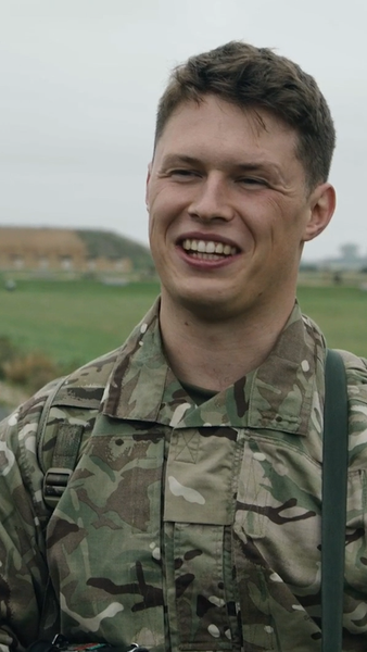 Male reservist outside laughing at camera