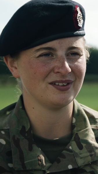 Female reserve on shooting range looking at camera