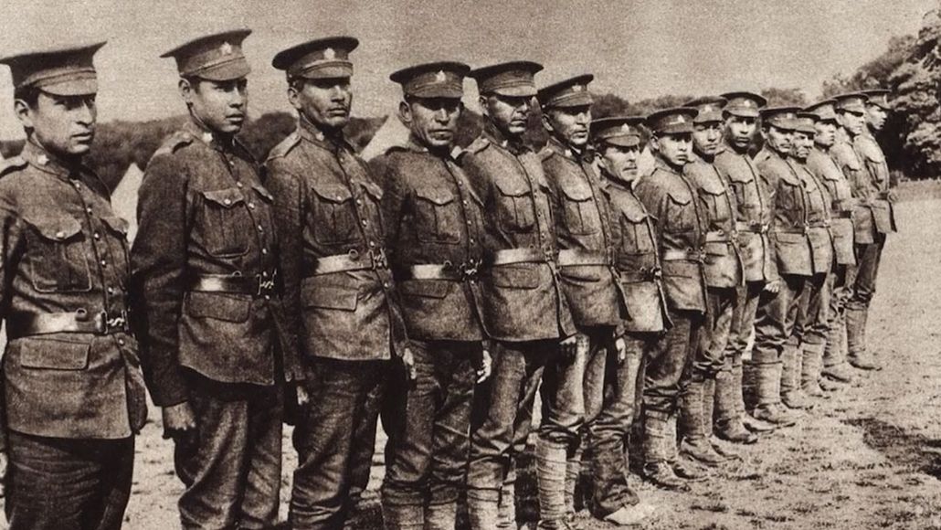 old black and white photo of soldiers lined up looking at the camera