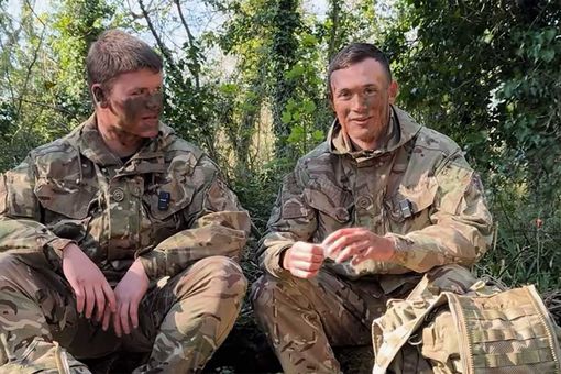 Two soldiers sitting in a woodblock