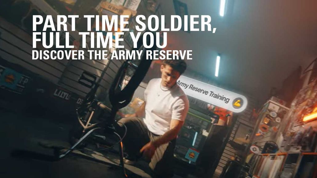 Man working on a motorcycle in a garage with "Part Time Soldier, Full Time You" text promoting the Army Reserve.