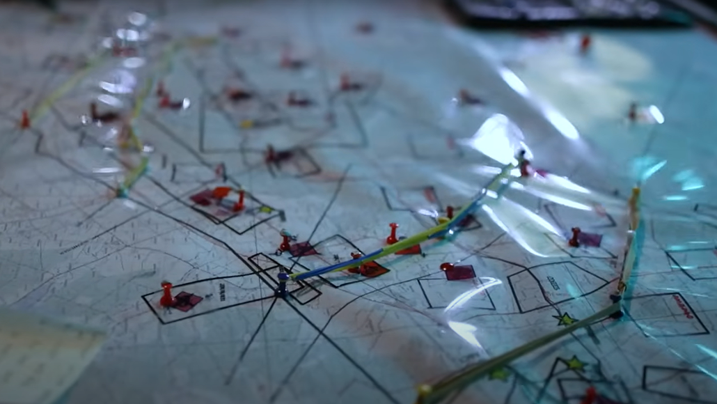 Closeup of a map with pins and string