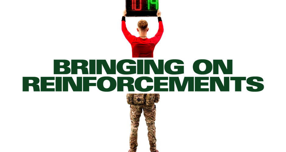 Referee holding a substitution board above text "BRINGING ON REINFORCEMENTS," blending sports and military themes.