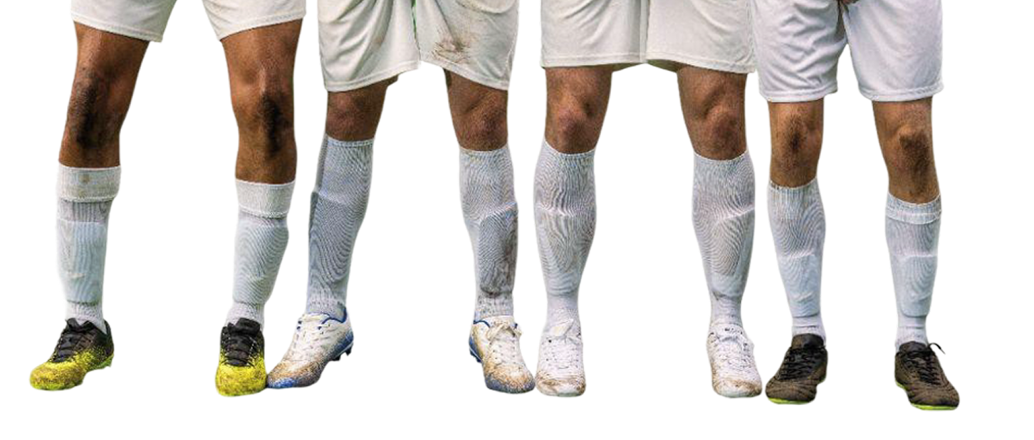 Six soccer players in white kits, lined up, showing only their legs and feet in different colored cleats on a black background.