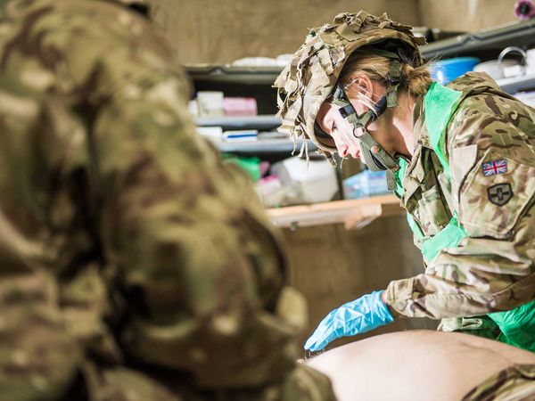 Army medic examining a soldier