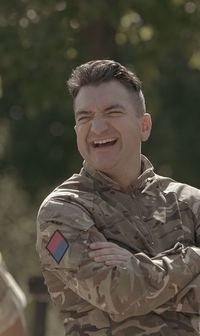 Reserve male in a group laughing