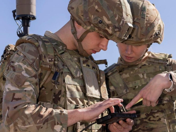 male and female soldier focusing on equipment