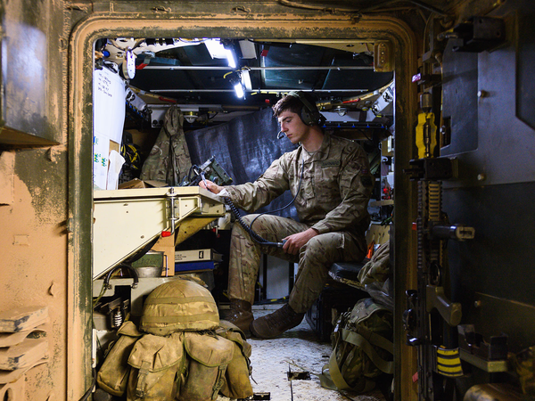Soldier in the a vehicle with headset on