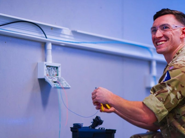 Soldier working on wires in the wall