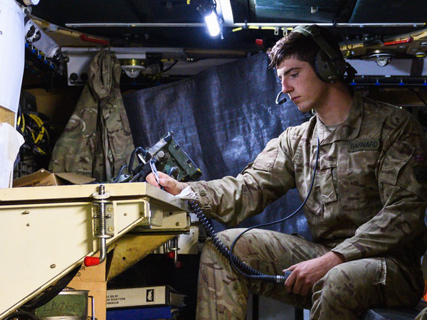Soldier in vehicle with headset on working