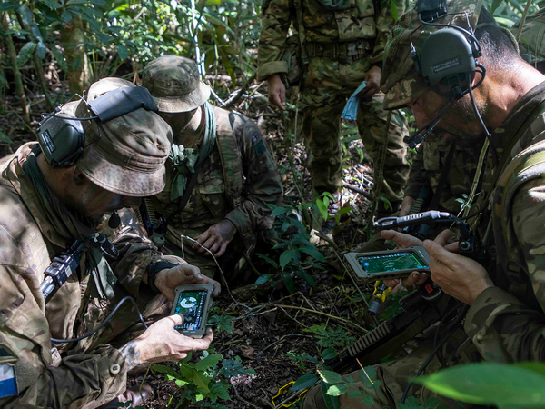 Soldiers in the jungle with signals equipment