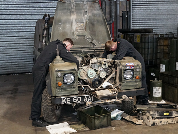 Mechanics working on a vehicle in a workshop
