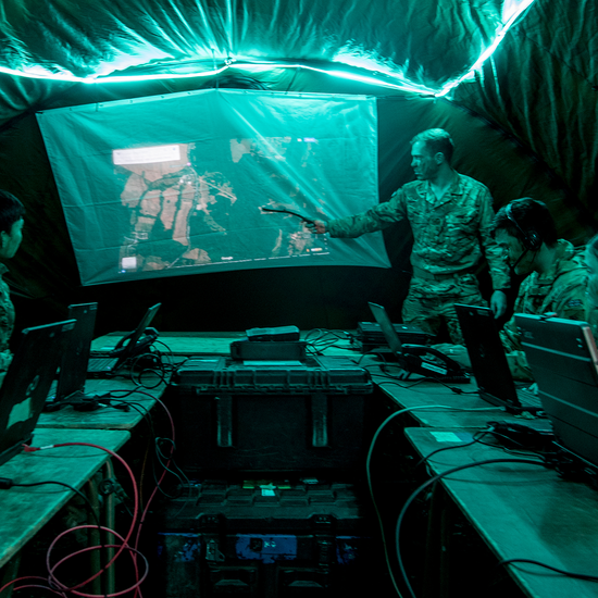 Team of Signal soldiers in a tent listening to briefing