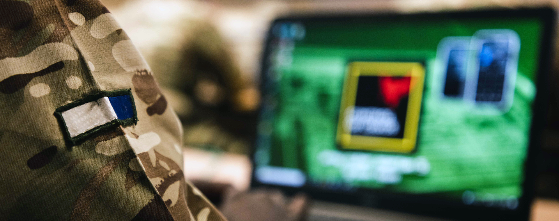 Closeup of a Signals soldiers badge as they focus on a computer screen