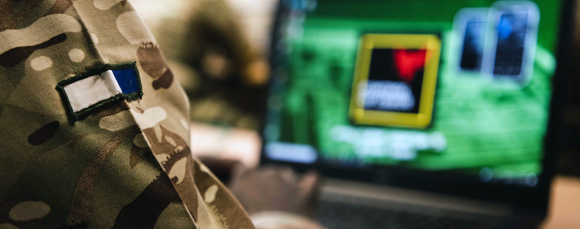 Closeup of a Signals soldiers badge as they focus on a computer screen