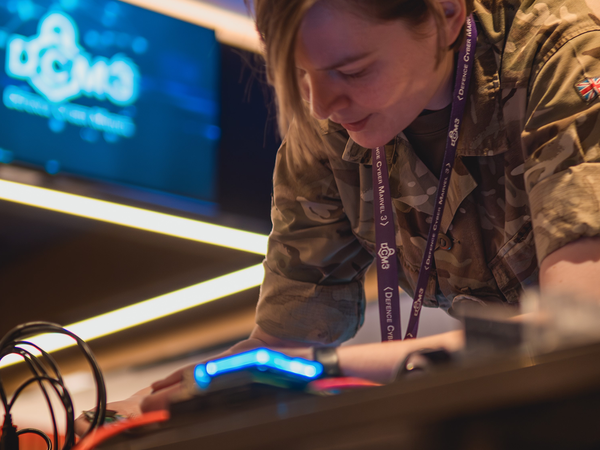 Female soldier working on electronic equipment