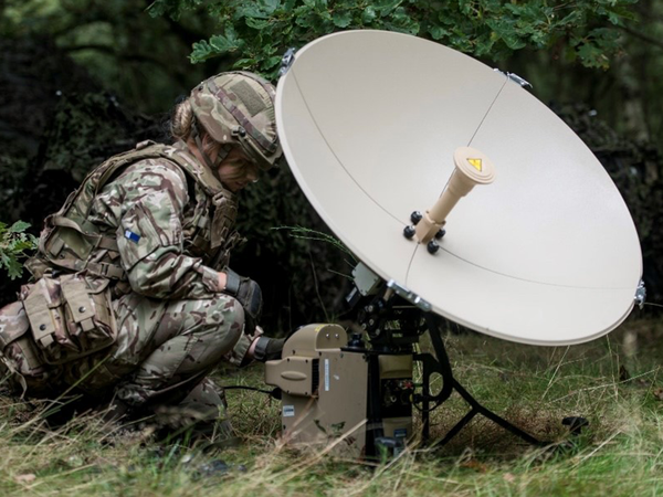 female soldier with a satellite dish in the field