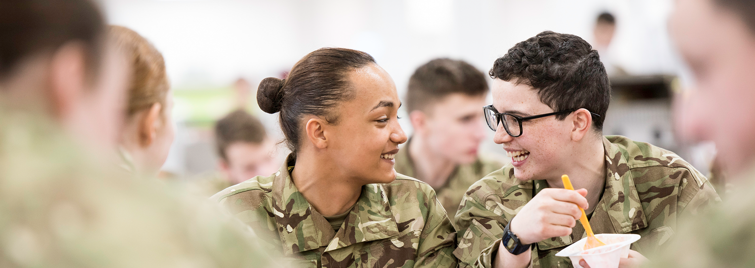 Junior soldiers eating and laughing in the canteen