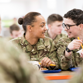 Junior soldiers eating and laughing in the canteen