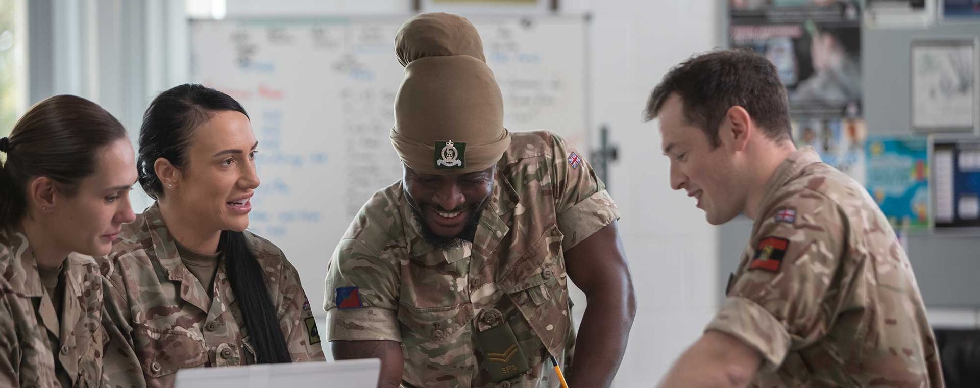 Soldiers and officer from the AGC in an office