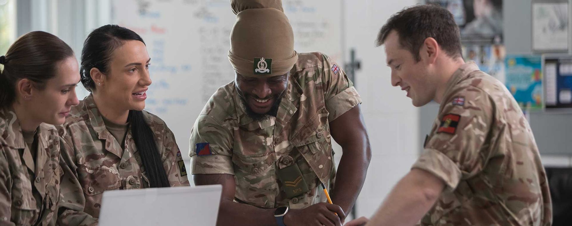 Soldiers and officer from the AGC in an office