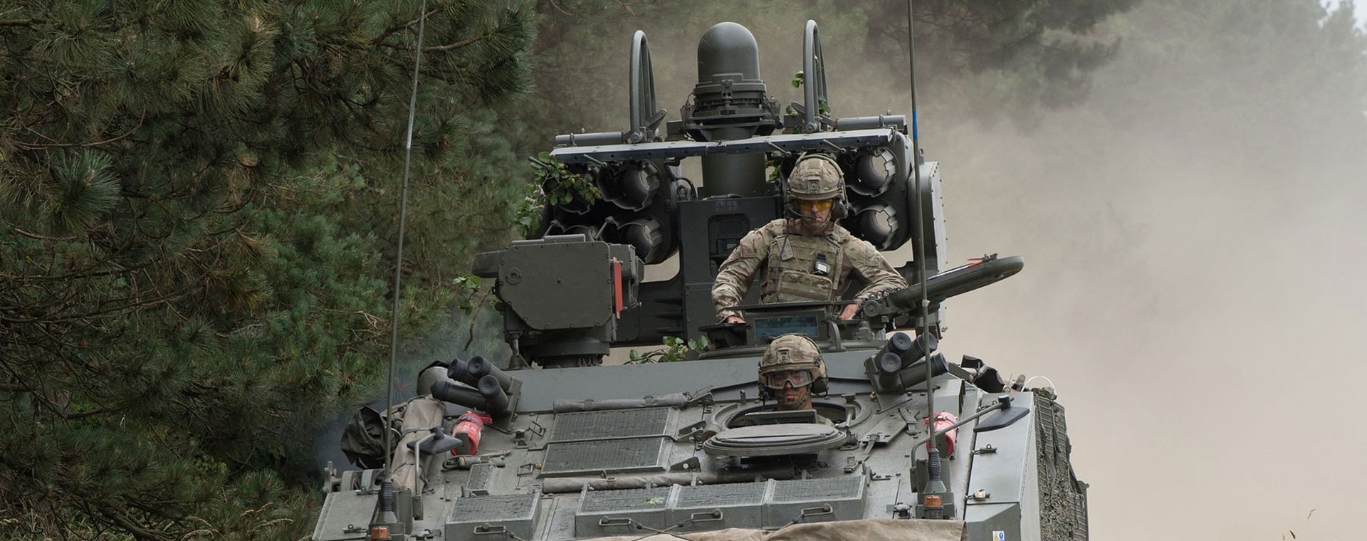 Gunners driving in an armoured vehicle