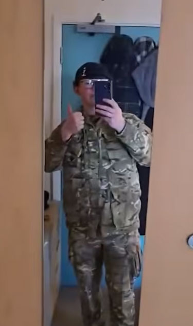 Soldier dressed in uniform taking a selfie in the mirror