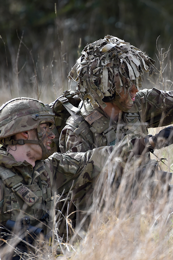 Two reservists in field on exercise pointing