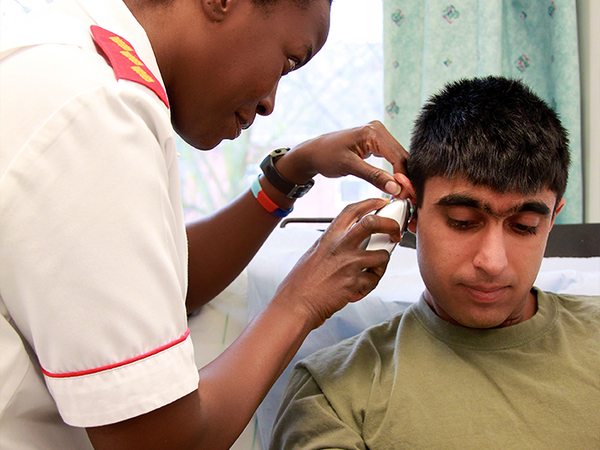 Nurse looking into a patients ear