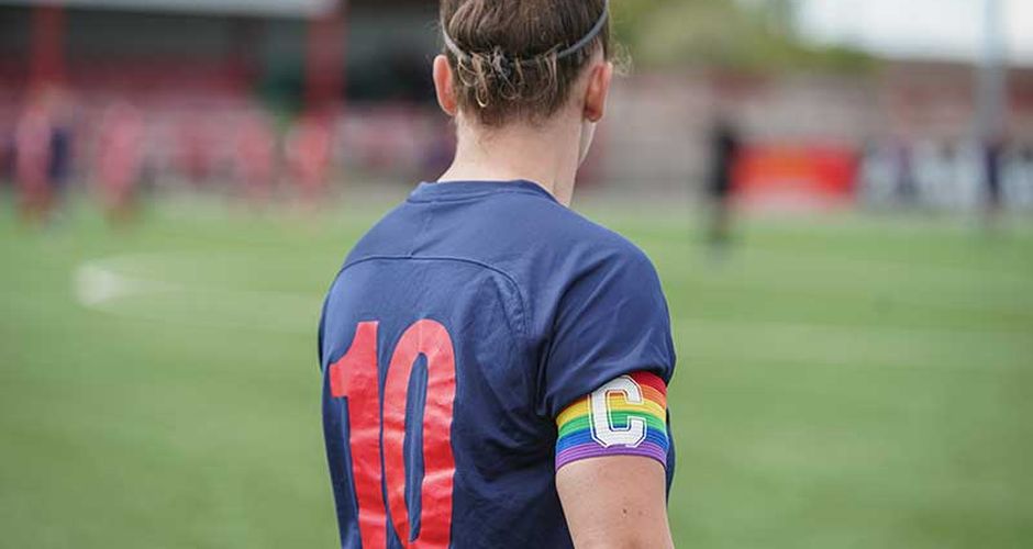 Footballer wearing a rainbow pride captain's arm band