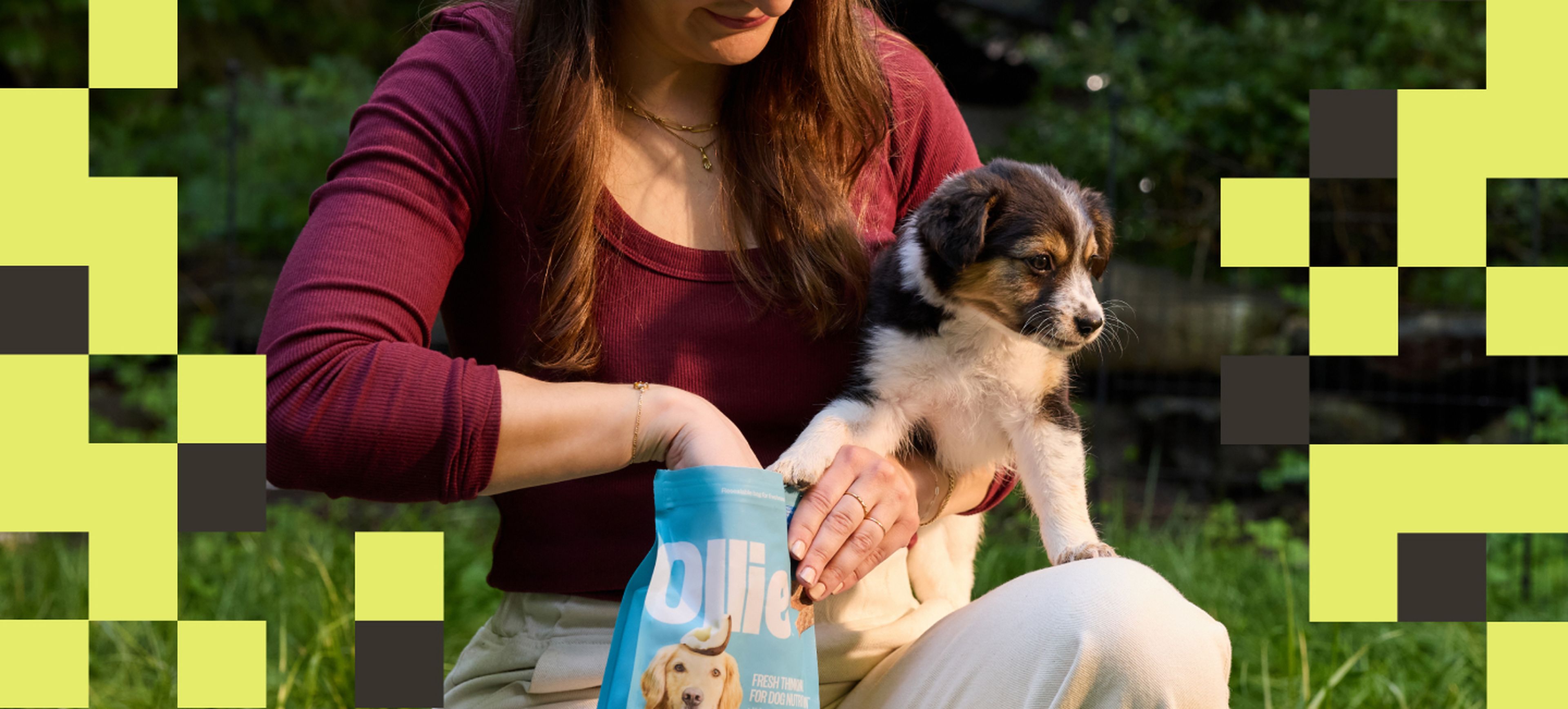 image of a woman feeding her dog Ollie treats out of a bag