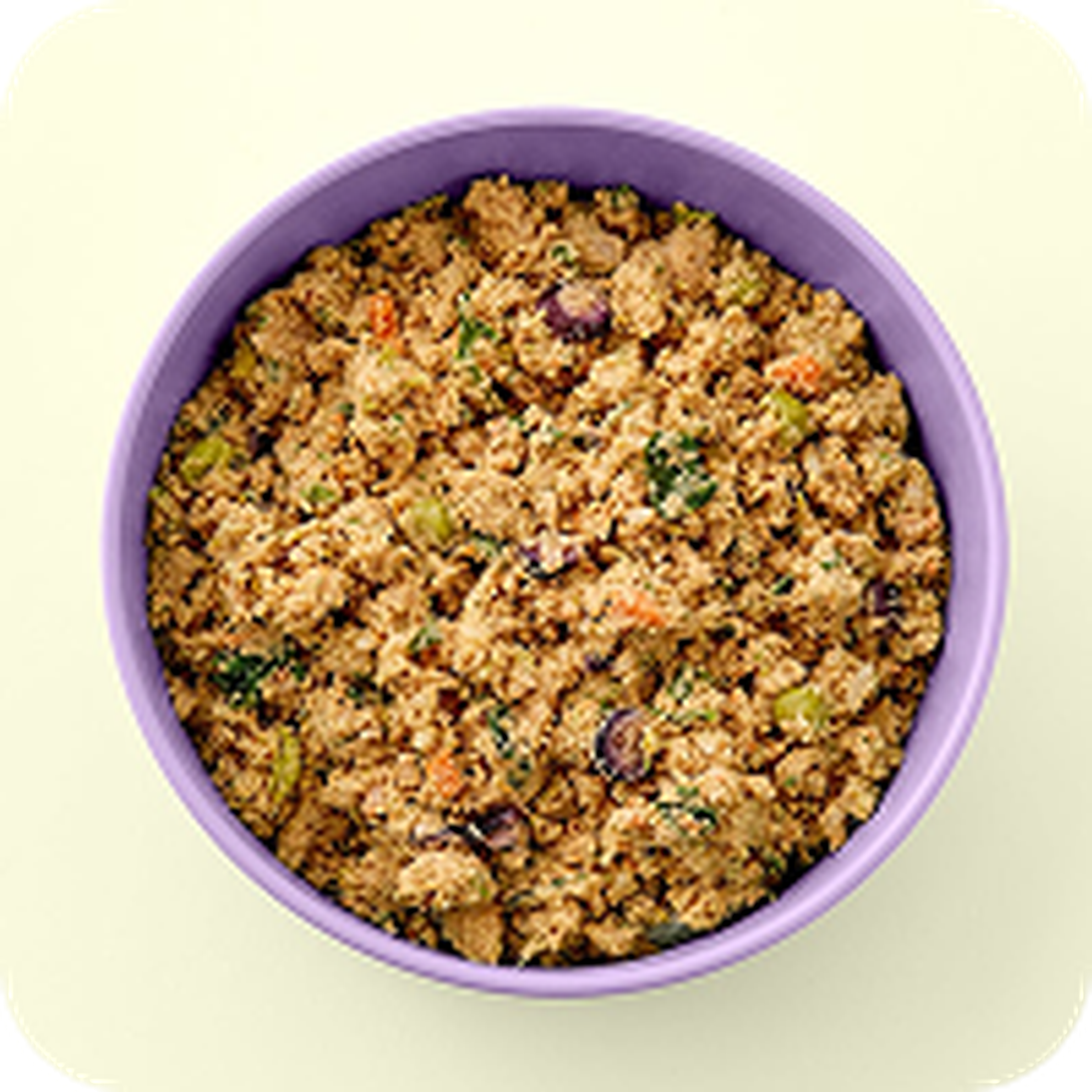 A bowl of crumbly vegan stuffing with colorful vegetables, served in a light purple dish on a pale background.
