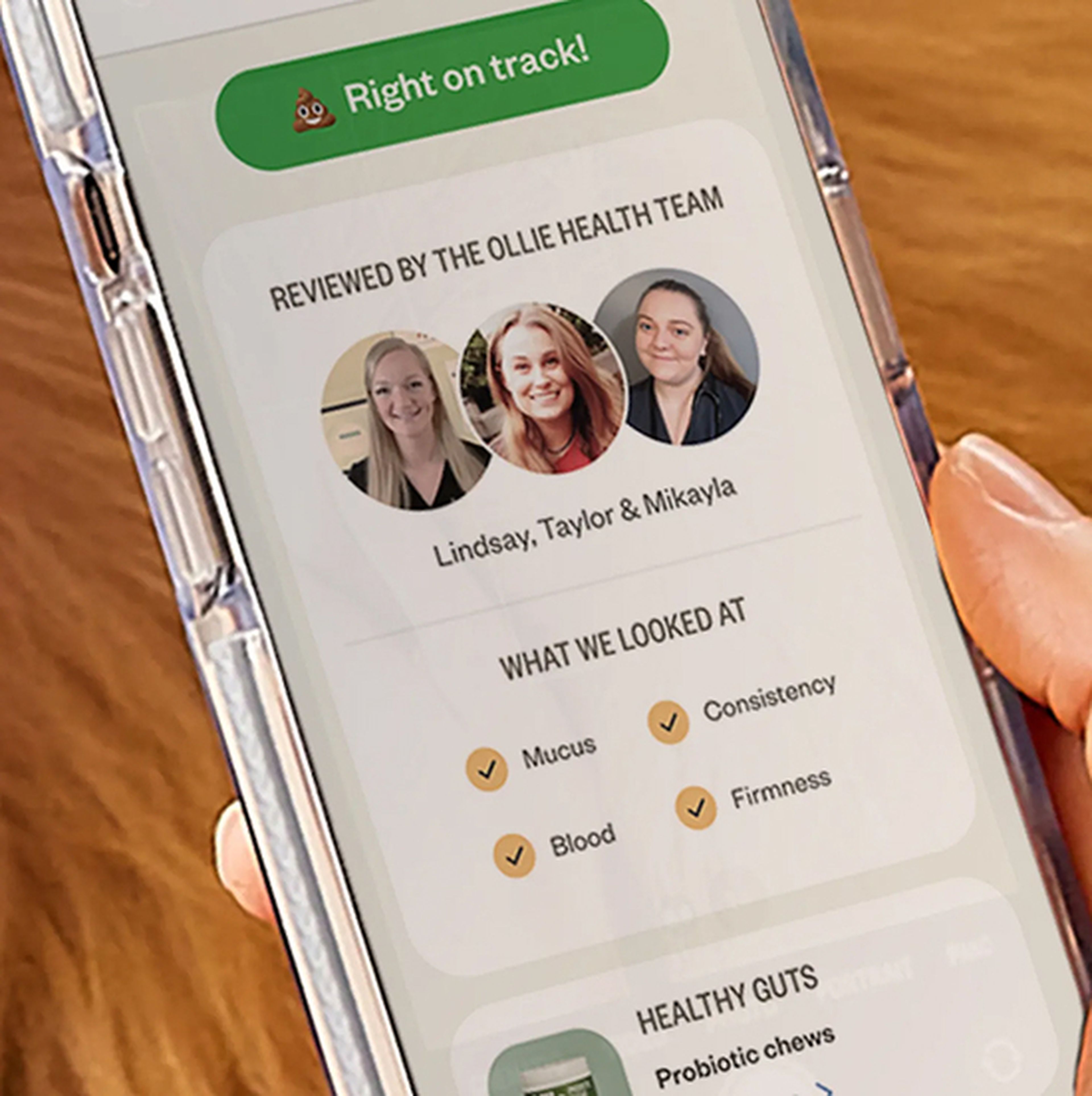 Phone screen showing a health app review by three team members, listing factors like mucus, consistency, blood, and firmness.