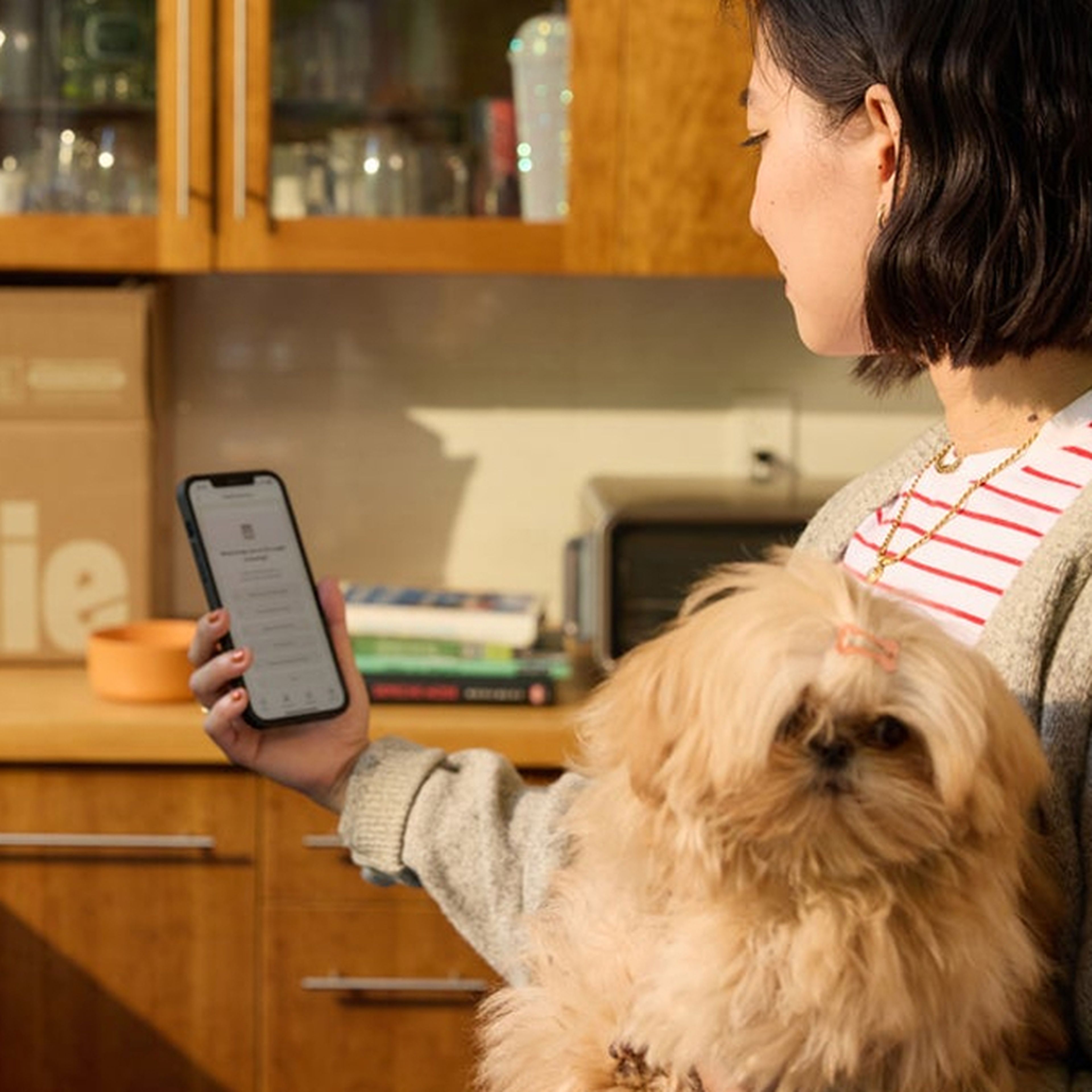 woman reading her pup's feeding guide on her phone