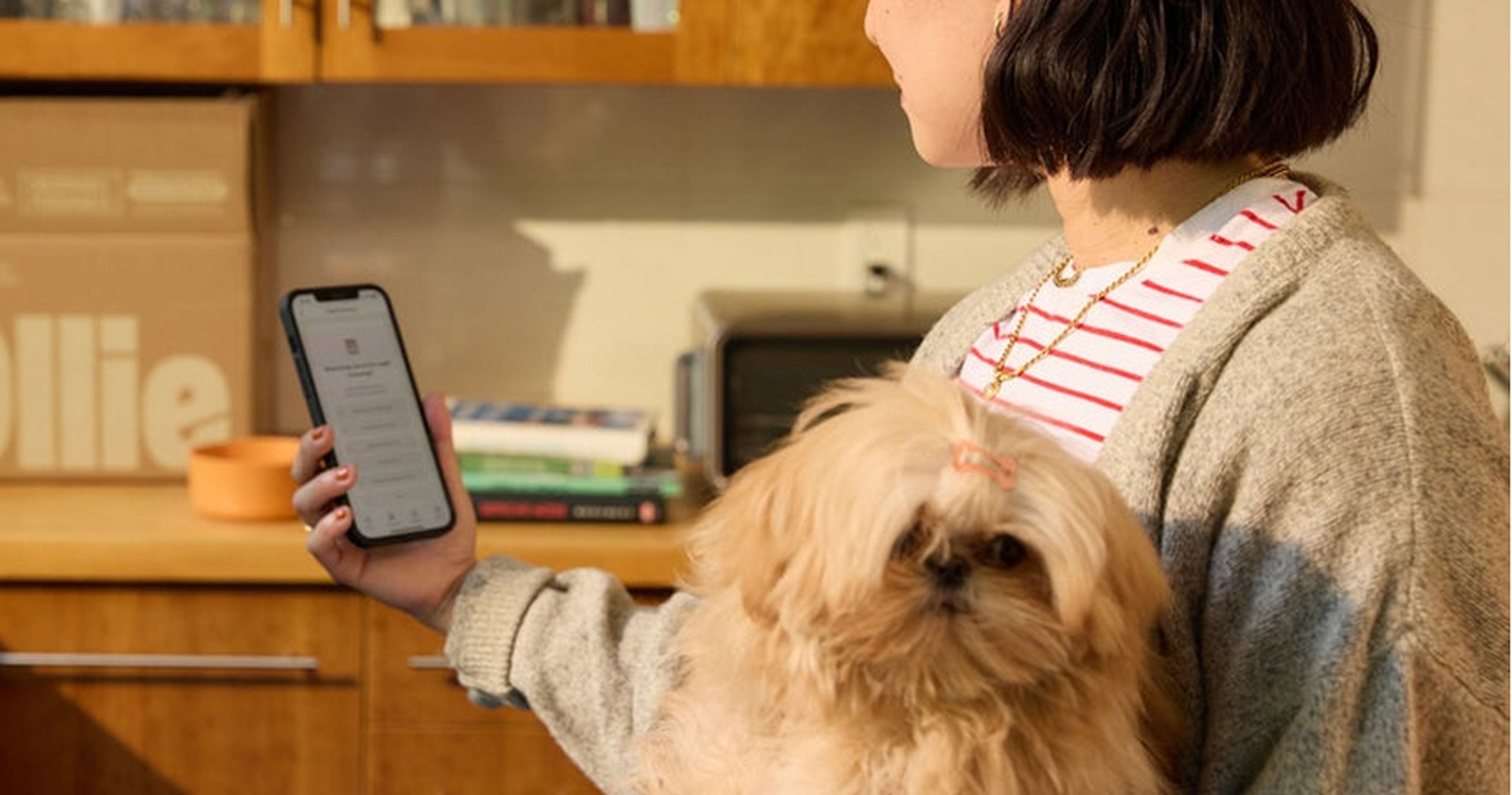 Woman reading her pup's feeding guide on her phone
