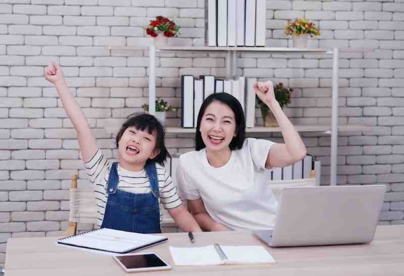 happy mom and daughter in online learning