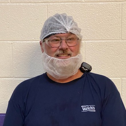 Welch's staff member smiling at work.