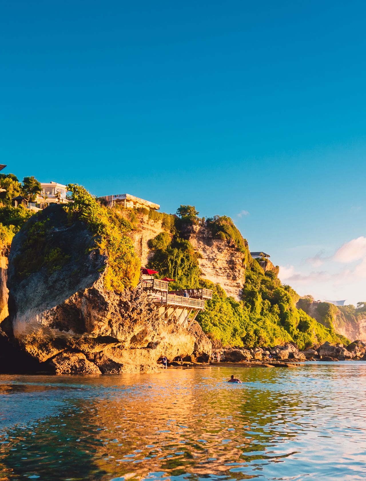 Blue sky, ocean and rocky cliff in Uluwatu, Bali