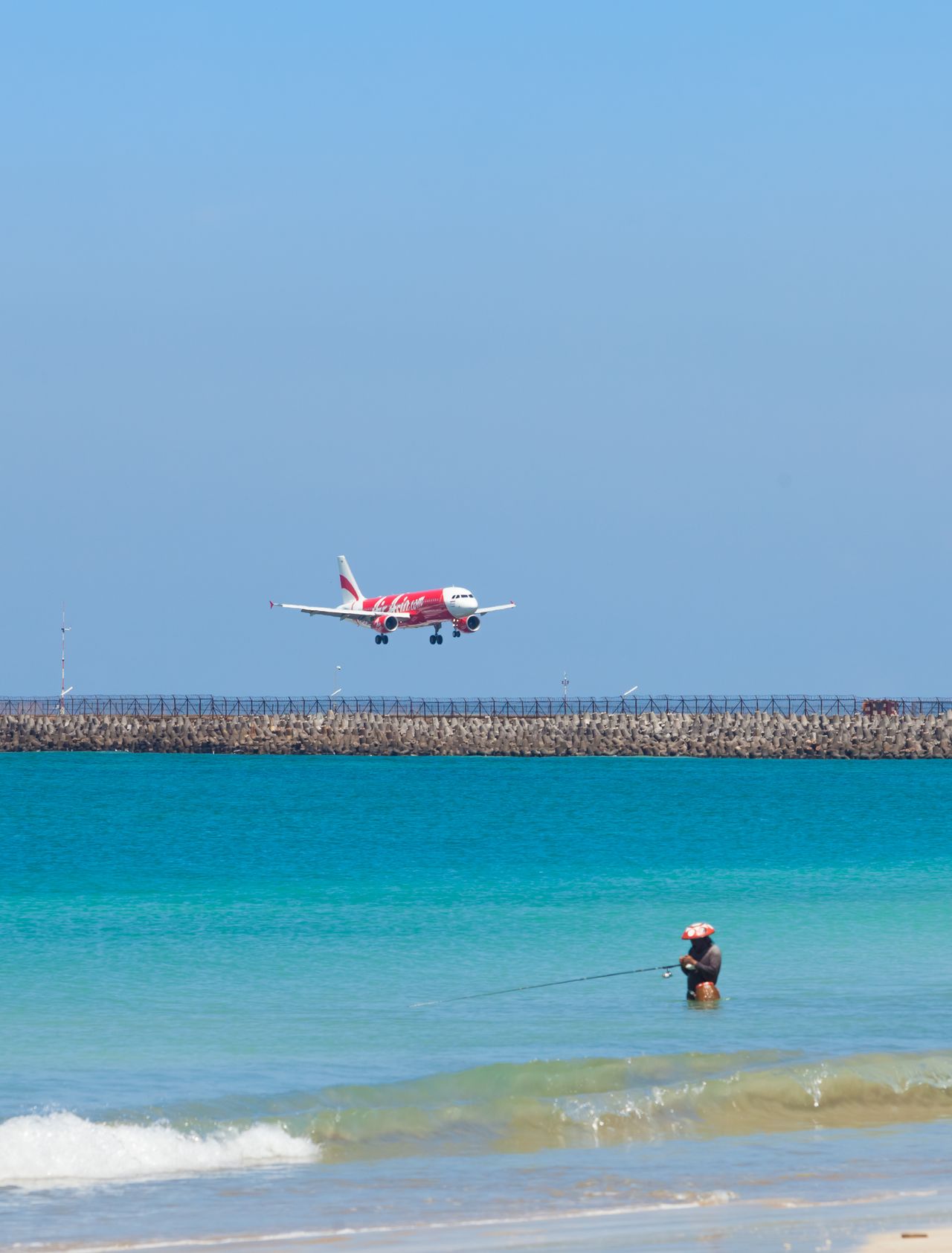 A plane flying over a beach in Bali, Indonesia.