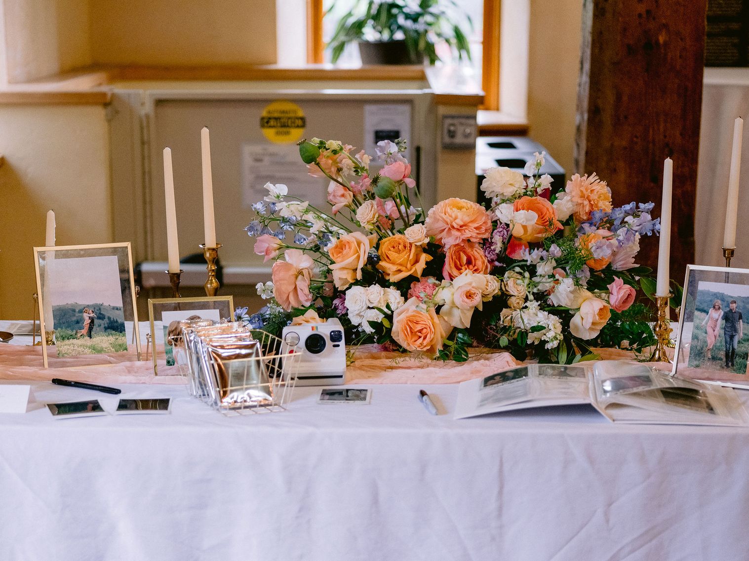 welcome table flowers with polaroid camera sign in scrapbook