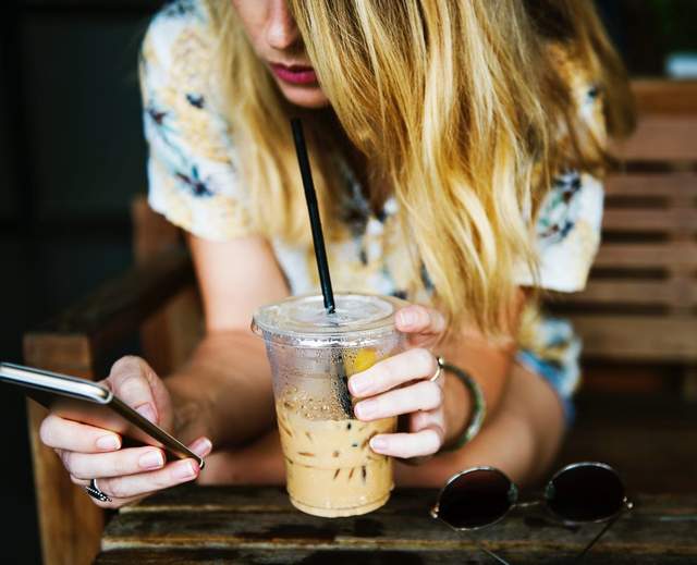 Lady with coffee and mobile phone