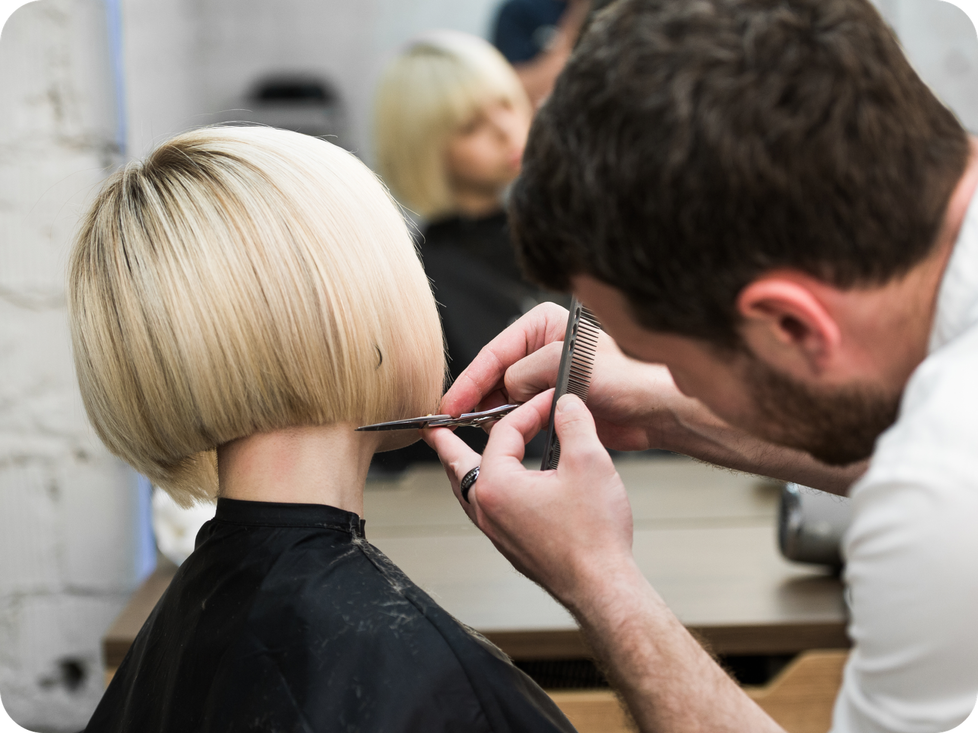 Hairdresser cutting hair