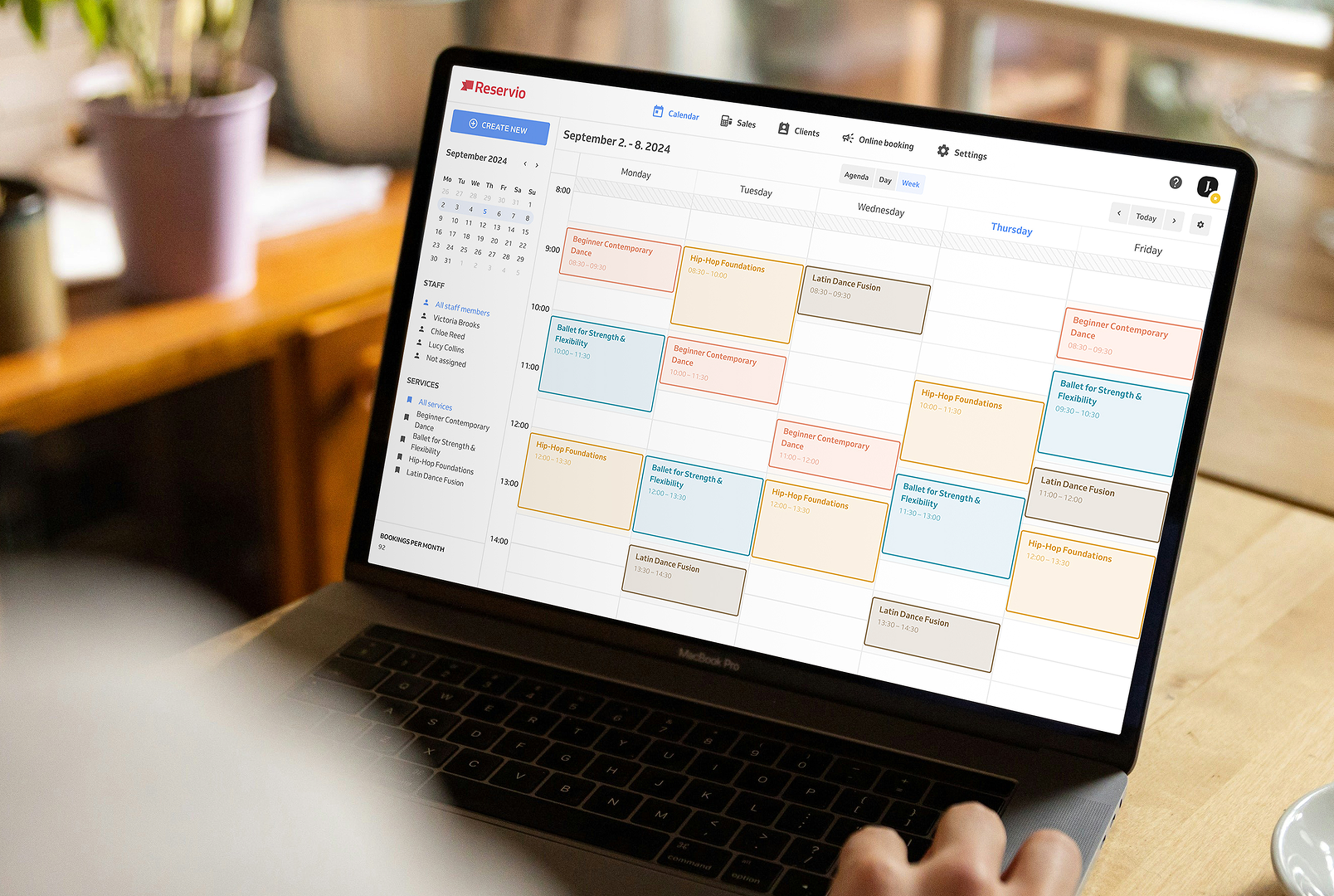 Computer with scheduling calendar full of bookings