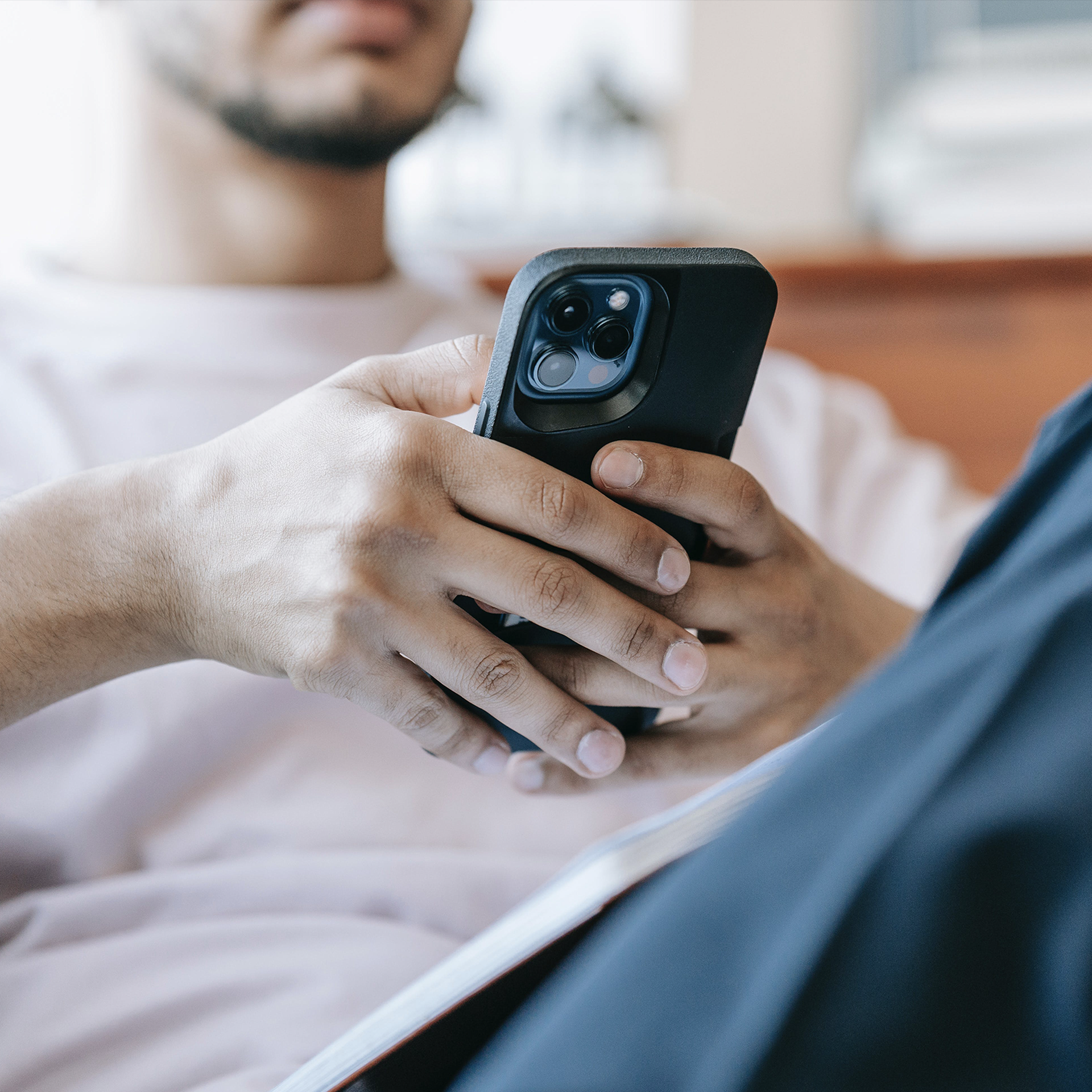 man scrolling on a smartphone